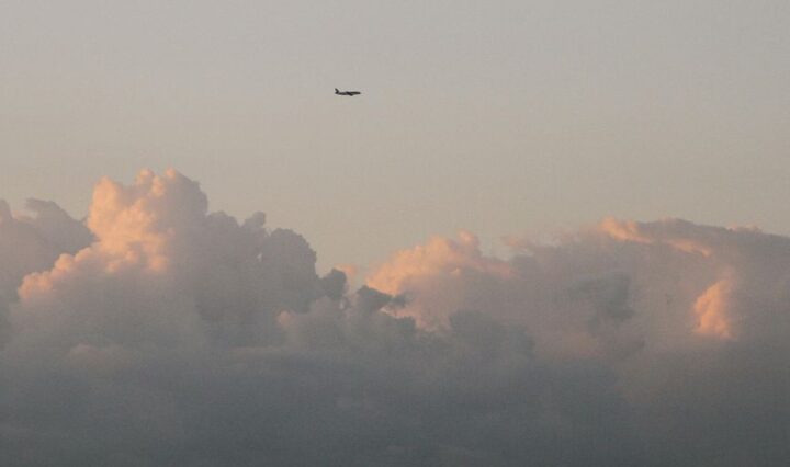 luxury private jet flying above clouds