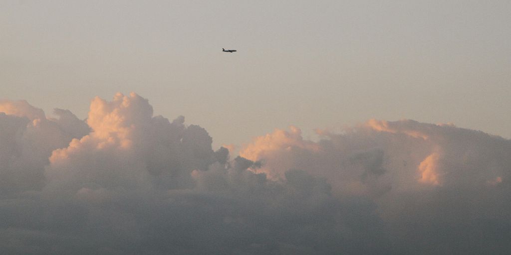 luxury private jet flying above clouds