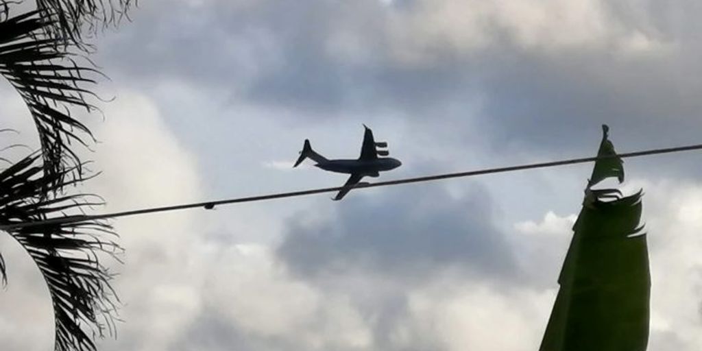 private jet flying over remote tropical island