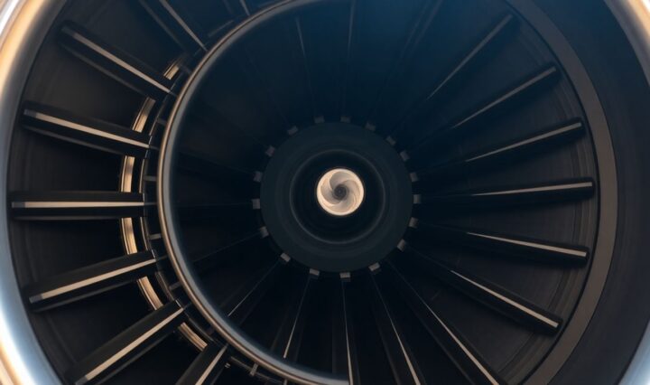 Rolls-Royce jet engine close-up, metallic components, turbine blades.
